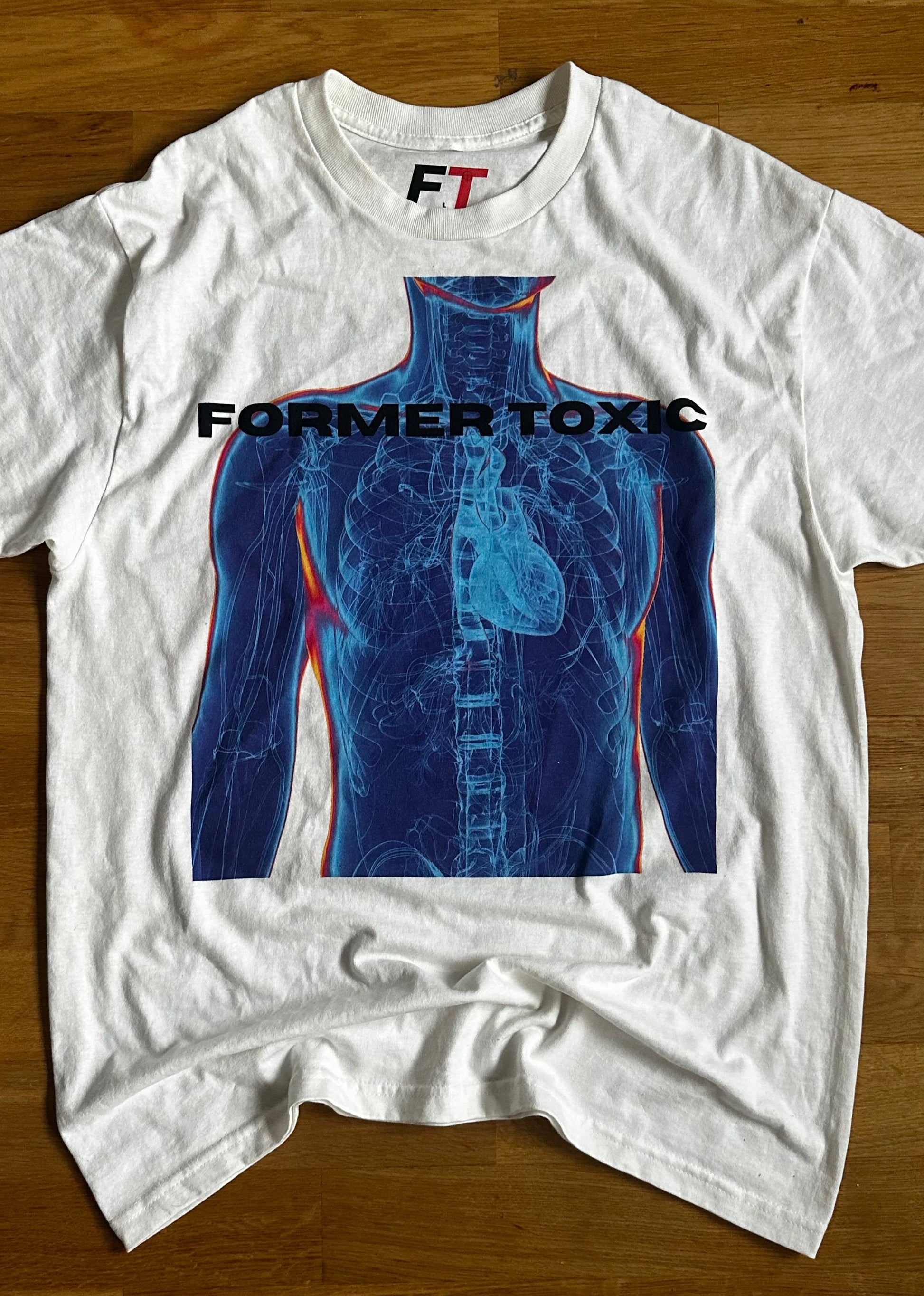 Former Toxic X-Ray Tee featuring blue thermal anatomy torso graphic on white shirt.